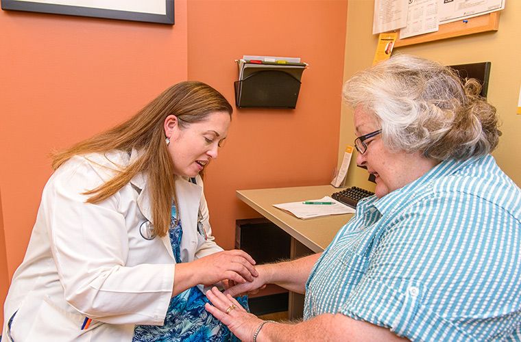 Photo of rheumatologist caring for patient.
