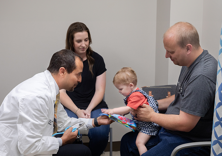 Dr. Rony Marwan plays with Eli during a clinic visit at the Children’s Specialty Center in Columbia.