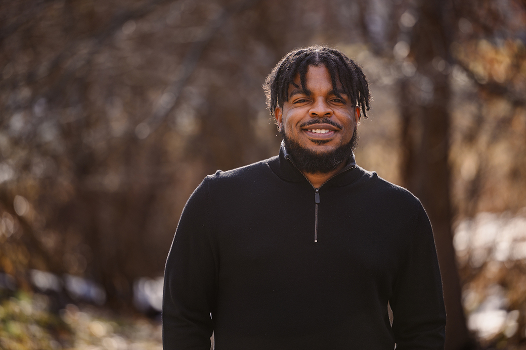 A man smiling outdoors.