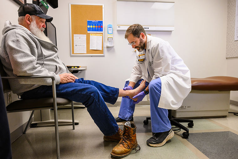 Schweser examines Frank’s artificial ankle joint during a follow-up appointment in Columbia.