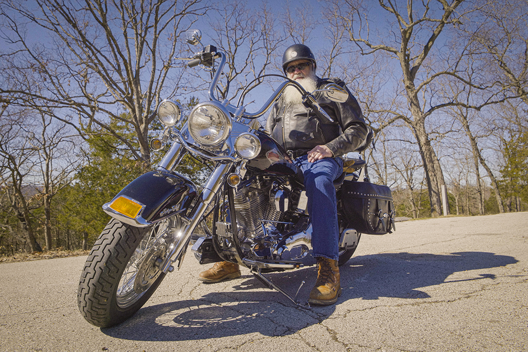 A photo of a man on a motorcycle.