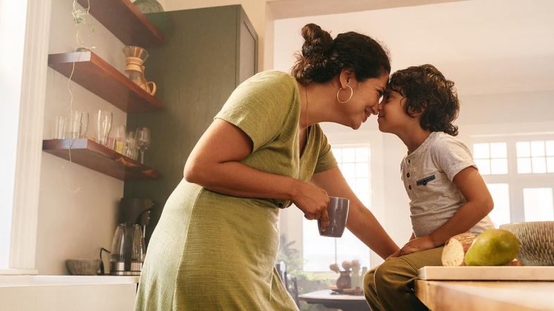 A mother and child in the kitchen.