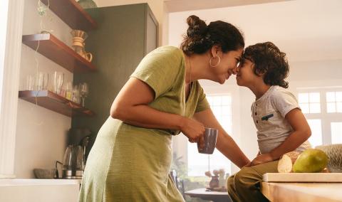 A mother and child in the kitchen.