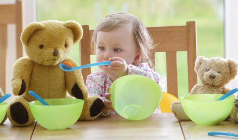 A child playing with toys at a table.