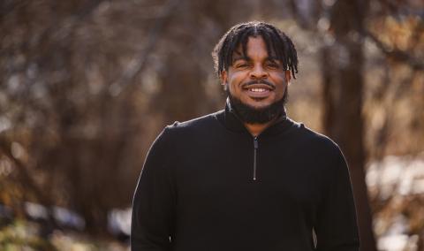 A man smiling outdoors.