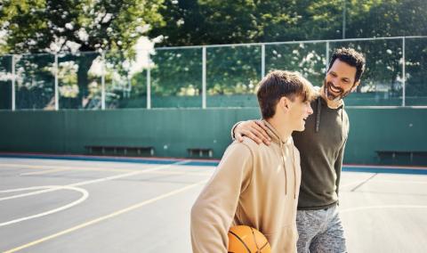 A father and son on the basketball court.