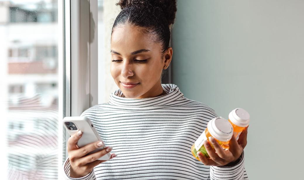 This is an image of a woman holding a bottle of pills.