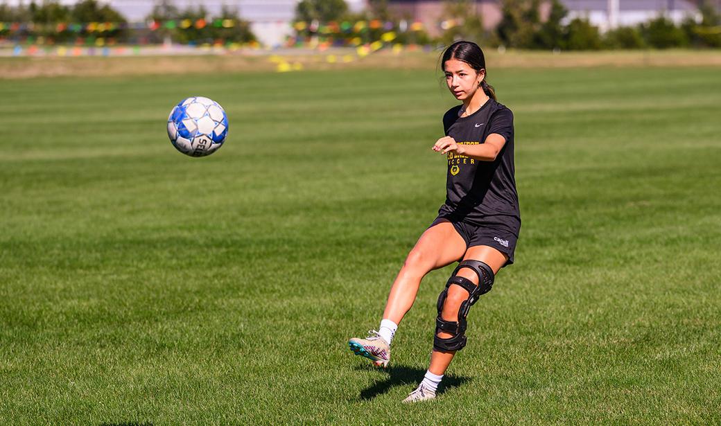 A photo of a girl playing soccer.