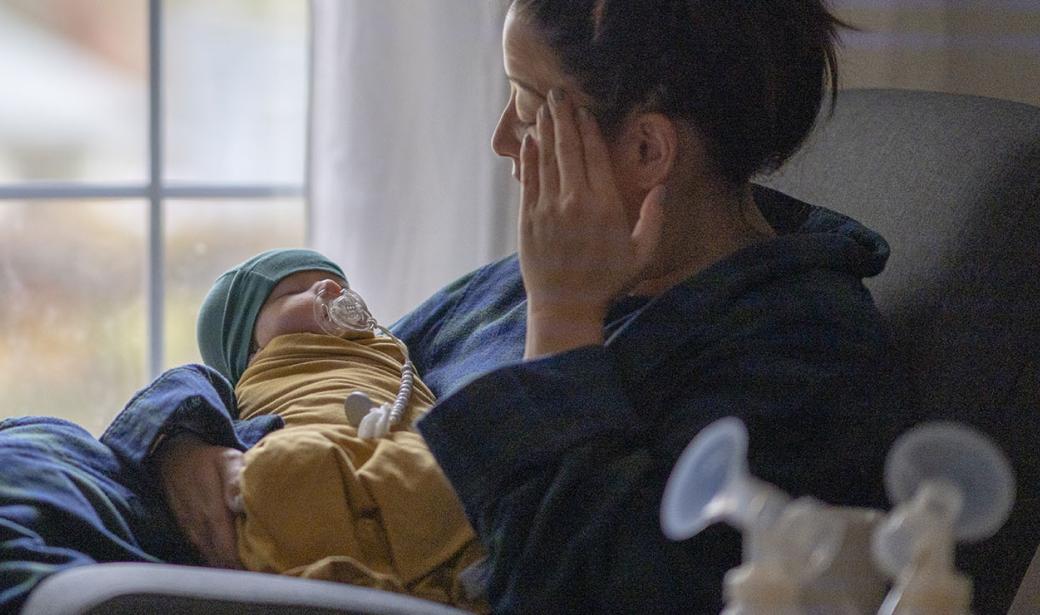 A mother holding her newborn child.