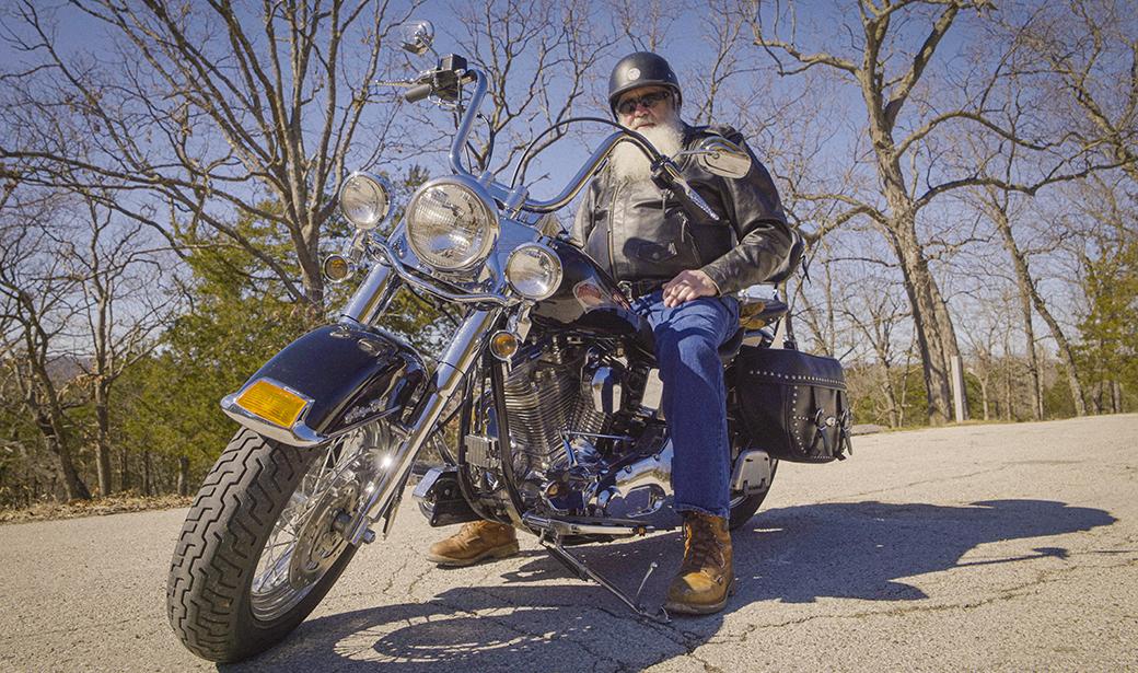 A photo of a man on a motorcycle.